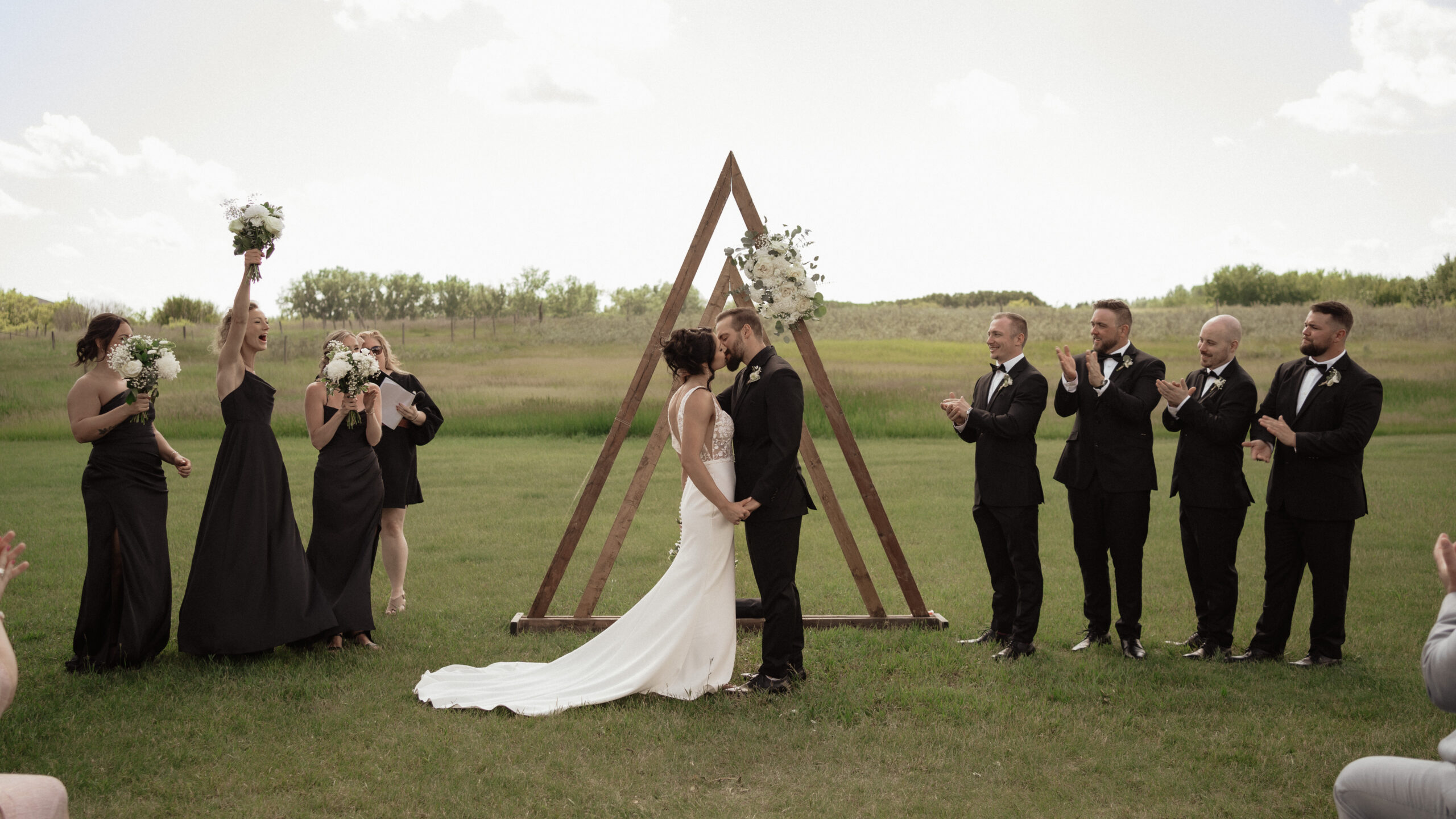 Bride and Groom First Kiss during Intimate Wedding Ceremony at The Station in Pilot Butte Saskatchewan