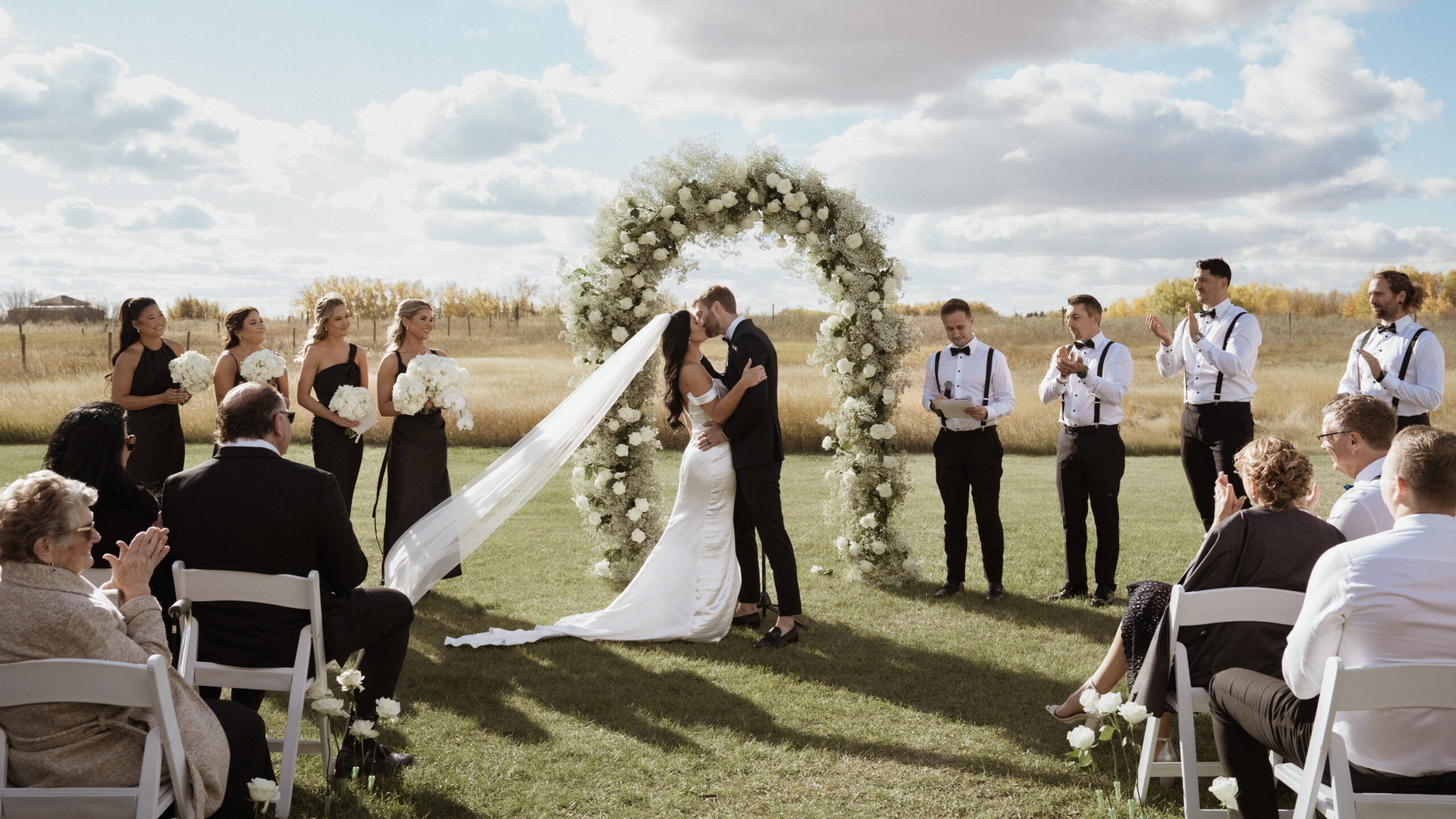 Bride and Groom share their first kiss at their intimate outdoor saskatchewan wedding